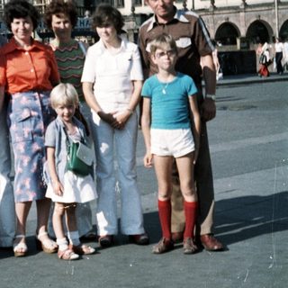 Family group photo in front of historic town square clock tower.