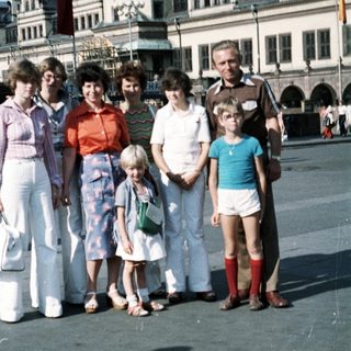 Family group photo in front of historic town square clock tower.