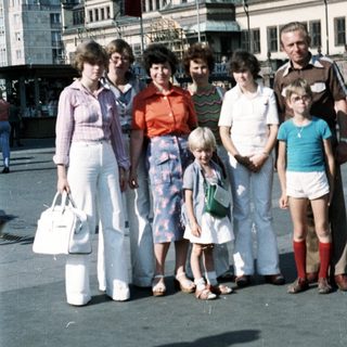 Family group photo in front of historic town square clock tower.