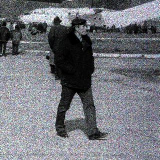 Large aircraft on snowy airfield with crowd observing.