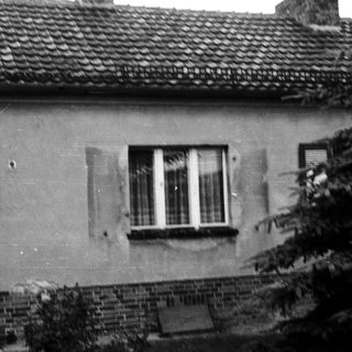 Agrarian-style house exterior with aged walls.