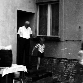 Blurred motion shot of man and child near doorway.