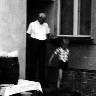 Blurred motion shot of man and child near doorway.