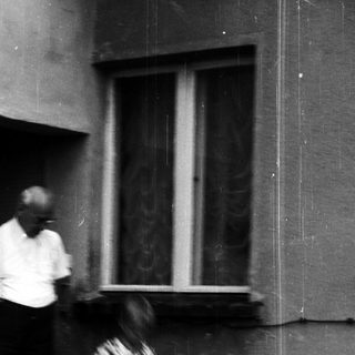 Blurred motion shot of man and child near doorway.