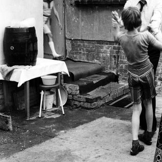Children playing outside with adult supervising.
