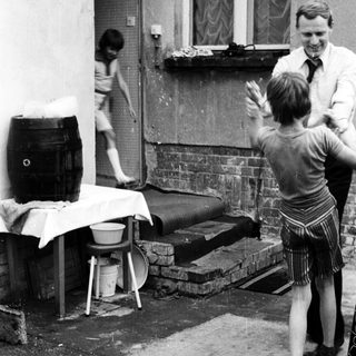 Children playing outside with adult supervising.