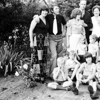 Family group photo outdoors in the 1970s–1980s.