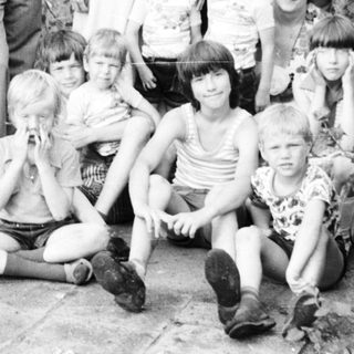 Family group photo outdoors in the 1970s–1980s.