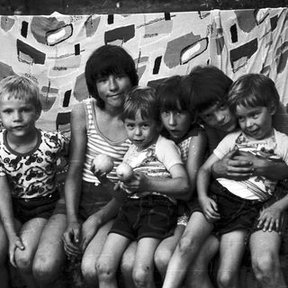 Family group photo with five children and one adult.
