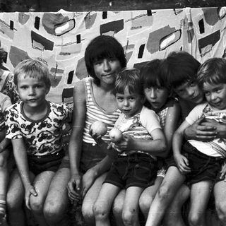 Family group photo with five children and one adult.