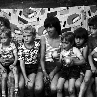 Family group posing together outdoors in 1970s-style clothing.