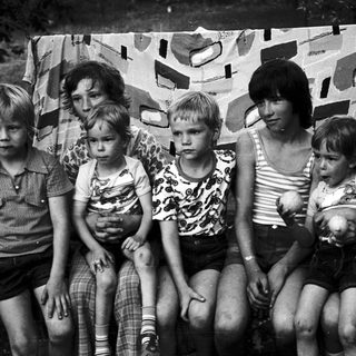 Family group posing together outdoors in 1970s-style clothing.