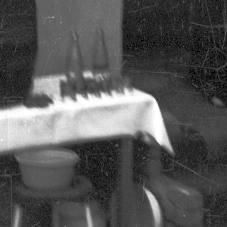 Blurred reflection of person playing piano indoors.