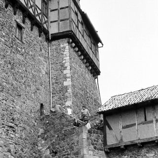 Medieval stone tower with timber-framed extension.