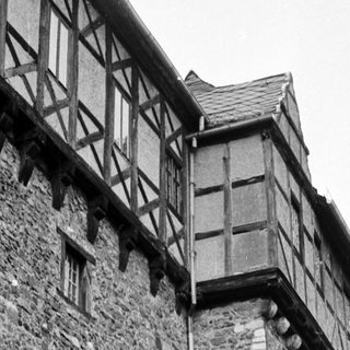 Medieval stone tower with timber-framed extension.
