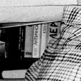 Young man using vintage radio with headphones.
