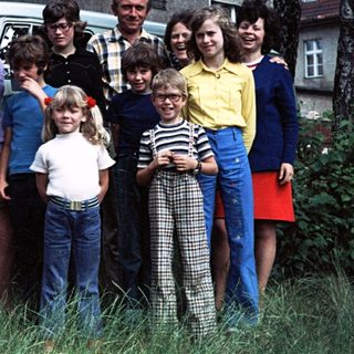 Family group photo with Volkswagen van, 1970s-80s.