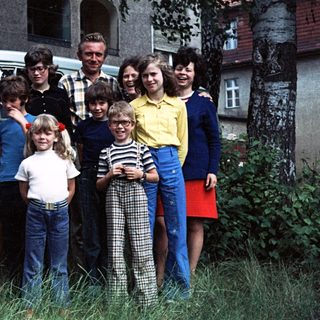 Family group photo with Volkswagen van, 1970s-80s.
