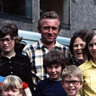 Family group photo with Volkswagen van, 1970s-80s.