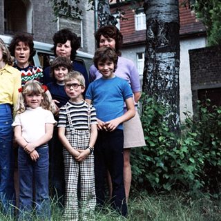 Family group photo with vintage Volkswagen van.