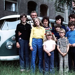 Family group photo with vintage Volkswagen van.