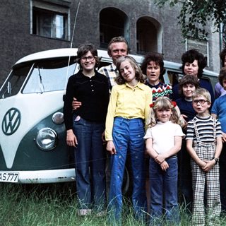 Family group photo with vintage Volkswagen van.