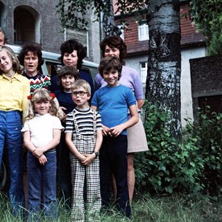 Family group photo with vintage Volkswagen van.