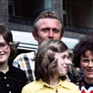 Family group photo with camper van, mid-1970s to 1980s.