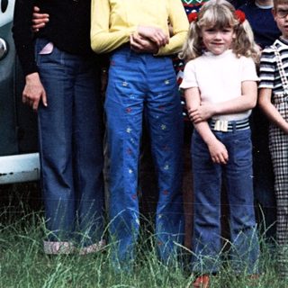 Family group photo with camper van, mid-1970s to 1980s.