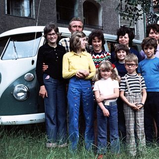 Family group photo with camper van, mid-1970s to 1980s.