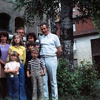 Family group photo in front of a van.