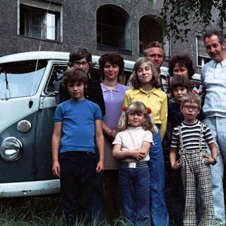 Family group photo in front of a van.