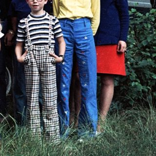 Family posing with vintage Volkswagen van.