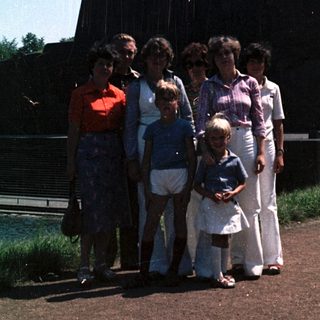 Family group photo near industrial monument.