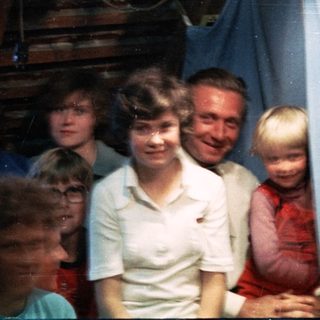 Family group posing indoors with festive paper lanterns.