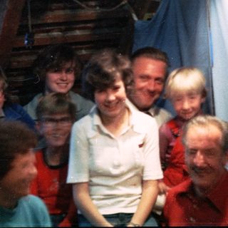 Family group posing indoors during festive celebration.