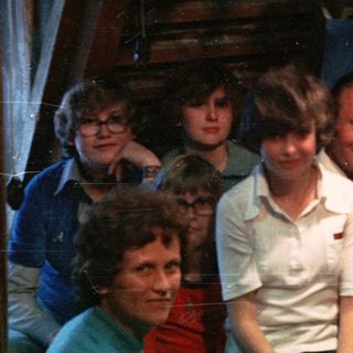 Family group in festive indoor setting with holiday decorations.