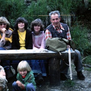 Family group photo outdoors during hiking trip.