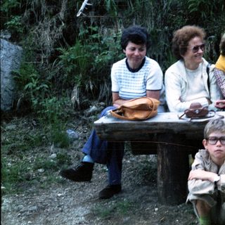 Family group photo outdoors during hiking trip.