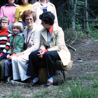Family group photo in forested outdoor setting.