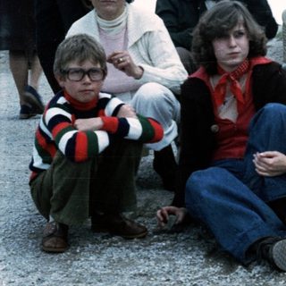 Family group posing outdoors in 1970s-80s attire.