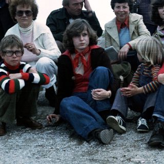 Family group posing outdoors in 1970s-80s attire.
