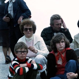 Family group posing outdoors in 1970s-80s attire.