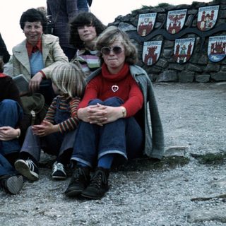 Family group posing outdoors in 1970s-80s attire.