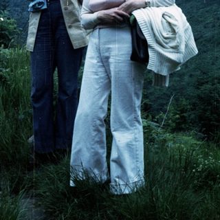 Two women hiking outdoors in vintage 1970s-80s attire.
