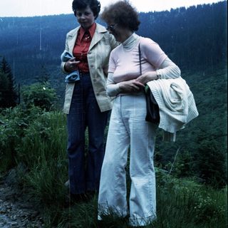 Two women hiking outdoors in vintage 1970s-80s attire.