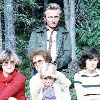 Family group photo in forested area, 1970s style.