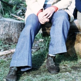 Family group photo in forested area, 1970s style.