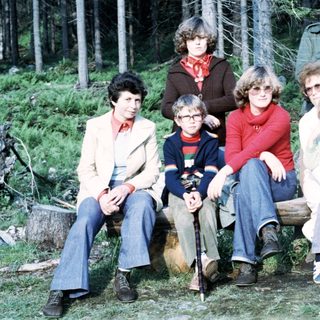 Family group photo in forested area, 1970s style.