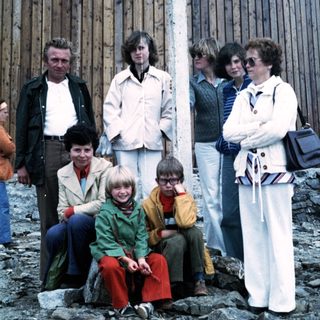 Family group photo outdoors in 1970s attire.